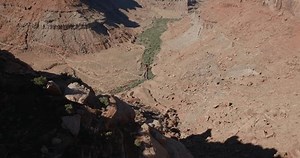 An individual slacklining over a deep canyon in Moab, Utah, capturing the thrill