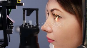 Eye examination and optometry to test your vision, medical consultation or glaucoma screening. Happy client with laser technology or eye scanning and ophthalmic test machine