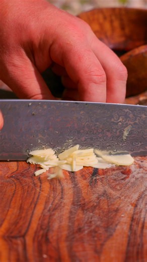 Aromatic spiced meat cooked on wooden posts over open fire, paired with freshly brewed coffee. Tradition meets flavor! #OutdoorCooking #GrilledMeat #OpenFireCooking #Cooking | Cook Loop