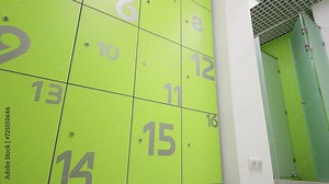 Lockers with numbers in dressing room with shower cabin