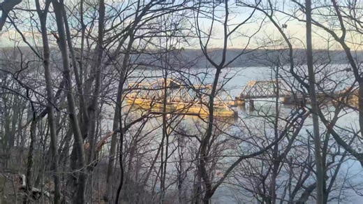 The Spuyten Duyvil Railroad Bridge, formerly of the New York Central Railroad, looking north from the Inwood Hills of Manhattan, in the open position to allow the Circle Line to pass through. The Spuyten Duyvil Creek becomes the Harlem River then East River consecutively as the connective navigable waterway around Manhattan. The site has been a rail crossing since the New York and Hudson River Railroad completed the first wooden span in 1849. An iron span replaced the wooden one in 1895, and the