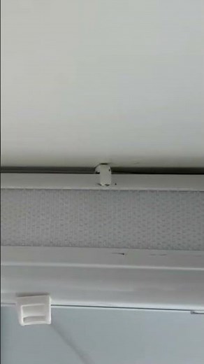 Removing a roman blind.