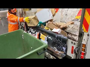 1100 being emptied into a Rear Loader