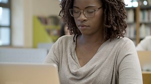 Free stock video - Closeup shot of serious african american woman using laptop
