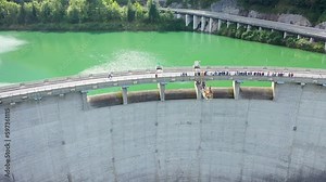 Aerial drone view of bungee jumping dam platform 50m high , viewers standing on dam bridge watching action happen.Klaus an der pyhrnbahn, Upper austria