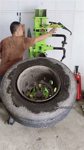 Precision wheel service: Heavy-duty tire demounting and replacement machine in action