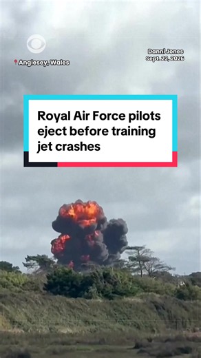 Video shows smoke rising from the wreckage of a Royal Air Force training jet in Wales on Wednesday, with two parachutes visible in the sky after the pilots ejected before the crash. Both pilots sustained minor injuries and are receiving treatment, according to local police. No other injuries or damage were reported. The RAF is investigating the cause of the crash.