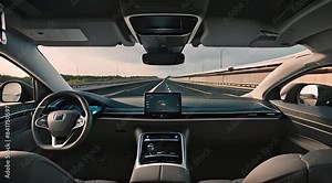 View from inside An autonomous self-driving car navigates on the highway with a digital interface