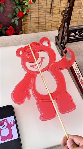 Draw a sweet strawberry bear lollipop with a spoon