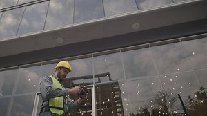 Man in hard hat flying a drone - Free Stock Video