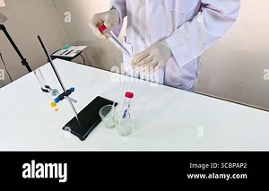 Scientist conducts a bromothymol blue experiment in a lab setting, showcasing chemical reactions and color changes Stock Video Footage - Alamy