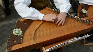 clip-2478698-girl-playing-lithuanian-stringed-instrument