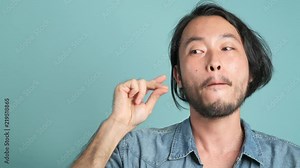 Man kissing bitcoin, e-trading concept. Young hipster pulling out gold bitcoin from his pocket and kissing it. Cryto currency trading concept.