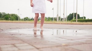 Toddler jumping in a puddle - Free Stock Video
