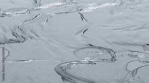 Water Dynamics in Action: Slow-motion video capturing the mesmerizing flow of water, accentuating the graceful movement of waves and ripples on the water surface Stock Video