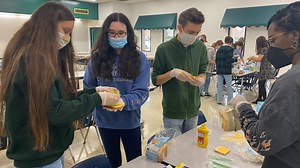 Cox High School students assemble over 1,800 sandwiches for those in need