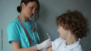 Teenager getting an swine flu shot. Flu vaccination, vaccination problems. Nurse gives a flu shot to a teenager boy