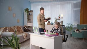 parent helping daughter with homework and reading dictation during distance lessons due to quarantine