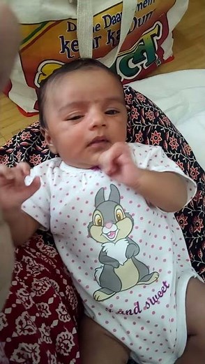 Baby sneezing and communicating with mom