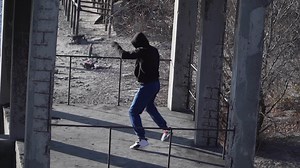 Download A guy Caucasian appearance A boxer black sweater with hood doing shadow boxing exercise against backdrop an abandoned building. Underground. Overall plan. Motivational video. Slow motion. for free