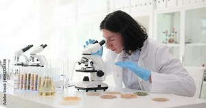 Long-haired worker detects presence of harmful bacteria using microscope and slams hands on table in anger slow motion. Technically advanced chemical laboratory