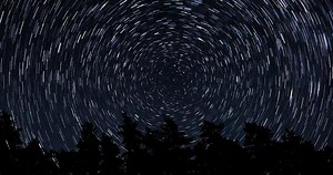 Stars move around a polar star. Time lapse of Star trails in the night sky. 4K