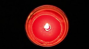 clip-1030172606-burning-candle-top-view-black-background