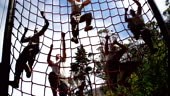 Military troops climbing a net during obstacle course at boot camp 4k