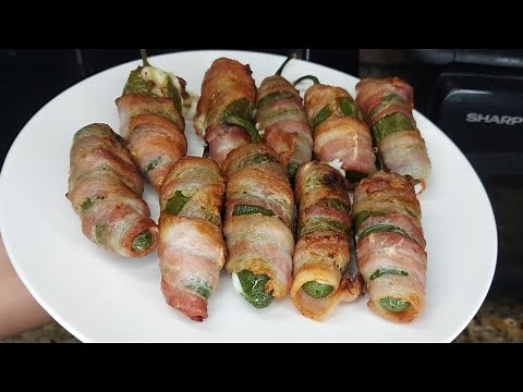 Jalapeño peppers stuffed with cheese and wrapped in bacon in an air fryer.