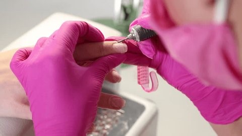 clip-4028811457-professional-manicurist-working-client