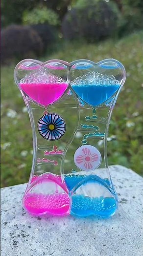 This is a double heart liquid motion bubbler timer, a sensory toy with pink and blue liquid.