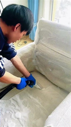 Cleaning sofa using vacuum cleaner for deep dust removal