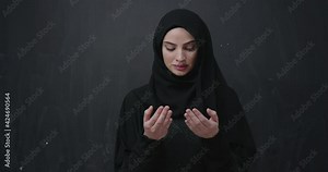 beautiful muslim woman wearing hijab making traditional prayer to God
