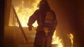 Brave Firefighter Runs Up The Stairs. In Slow Motion. Raging Fire is...