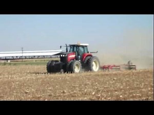Versatile 280 Tractor pulling a Dave Koenig ripper and packer in Arizona
