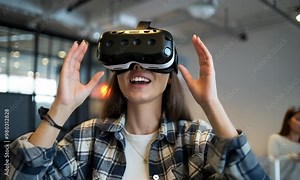 A young woman using virtual reality goggles, with a look of amazement.