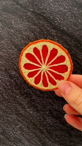 Come make an embroidered blood orange slice with me. 🍊 Stitched using freehand machine embroidery on water soluble fabric this little cutie will join its other fruity friends in an upcoming online release. 🍊🍋🍋‍🟩 #fruitembroidery #meredithwoolnough #sculpturalembroidery #freehandmachineembroidery #watersolublefabric | Meredith Woolnough Artist