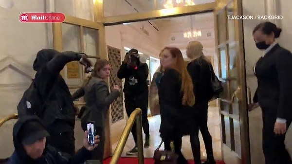 Lindsay Lohan commands attention in a chic black pantsuit while out in New York