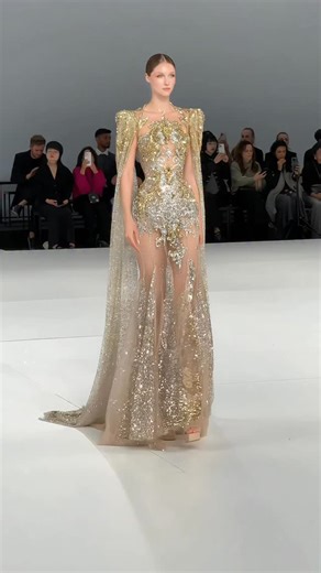 FORUS on Instagram: "The embroidery of champagne-colored tulle with alloy silver thread is like sewing a broken diamond galaxy on the skirt. The transparent mesh outlines a graceful curve. The gold-plated cloak design on the shoulder is full of aura, and the skirt sways when walking. #bridaldress #weddingdresses #luxurybridal #runway #jolipoli"