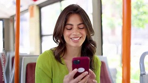 Happy Mexican woman having fun online while riding in a bus