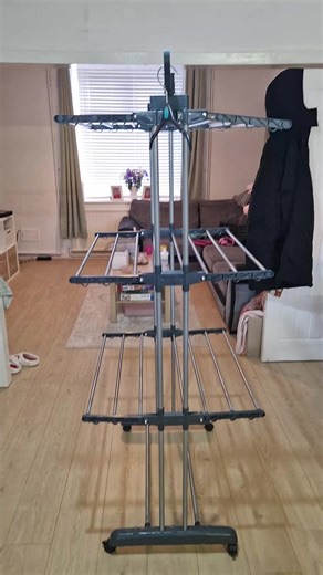 Laundry piles taking over your life? 😩 This 4-Tier Drying Rack is the ultimate apartment hack! Folds flat, holds three loads of laundry, and saves you money on the dryer. Get more space AND soft, fresh clothes! Stop air-drying on your chairs! 👇 #LaundryHacks #SmallApartmentLiving #SpaceSaving #HomeHacks #DryingRack