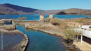 The famous canal of Elounda with the ruins of the old bridge, Crete, Greece.