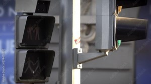 Green to red traffic LED light for pedestrians with 2 man sign symbolizing a Gay couple in a street of Madrid Stock Video