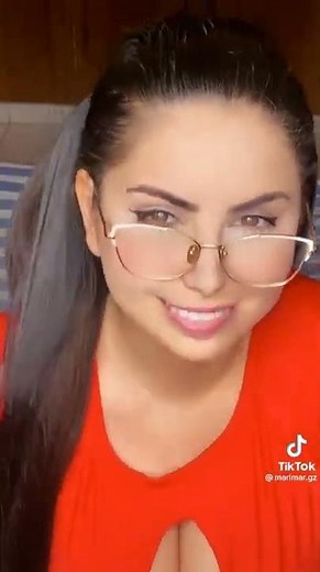 Sexy Busty Girl With Glasses Gives A Naughty Look And Smile In This TikTok Video