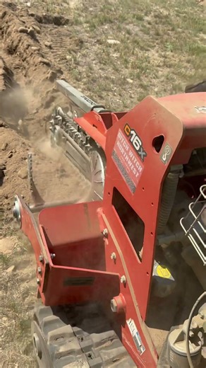 Ditch witch trencher trenching in very rocky soil