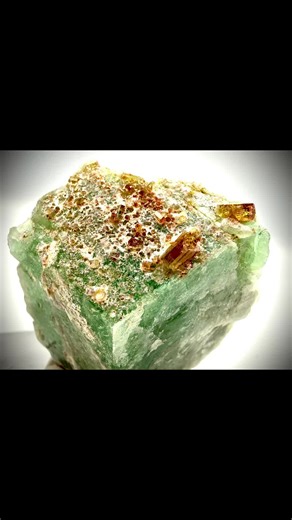 An exceptional and seldom-seen pairing — golden tourmaline crystals elegantly perched atop vibrant Vietnamese amazonite. The richly saturated green amazonite provides a striking backdrop for the lustrous, honey-colored tourmaline prisms scattered across the surface. Specimens displaying this association are extraordinarily rare, making pieces like this highly sought after by advanced collectors of fine minerals. A unique and aesthetic mineral specimen that beautifully showcases the diversity and