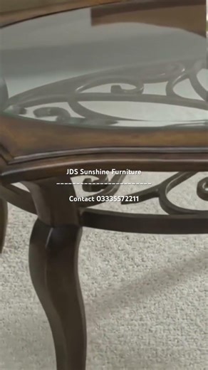 Oval coffee table features a filigree center encased in glass