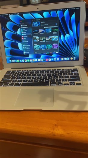 Radial Blue wallpaper on MacOS Sequoia 15.7.3 on a unsupported Mac