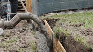 concreting of the foundation of the new building. pouring concrete into an excavation in the ground