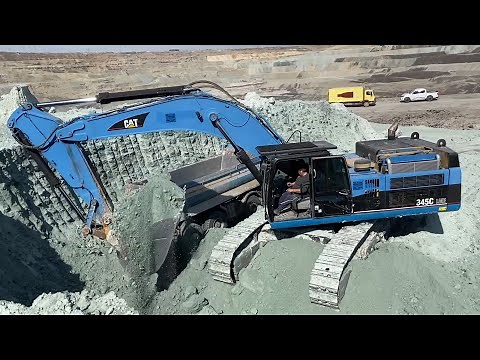 Blue Caterpillar 345C Excavator Loading Trucks